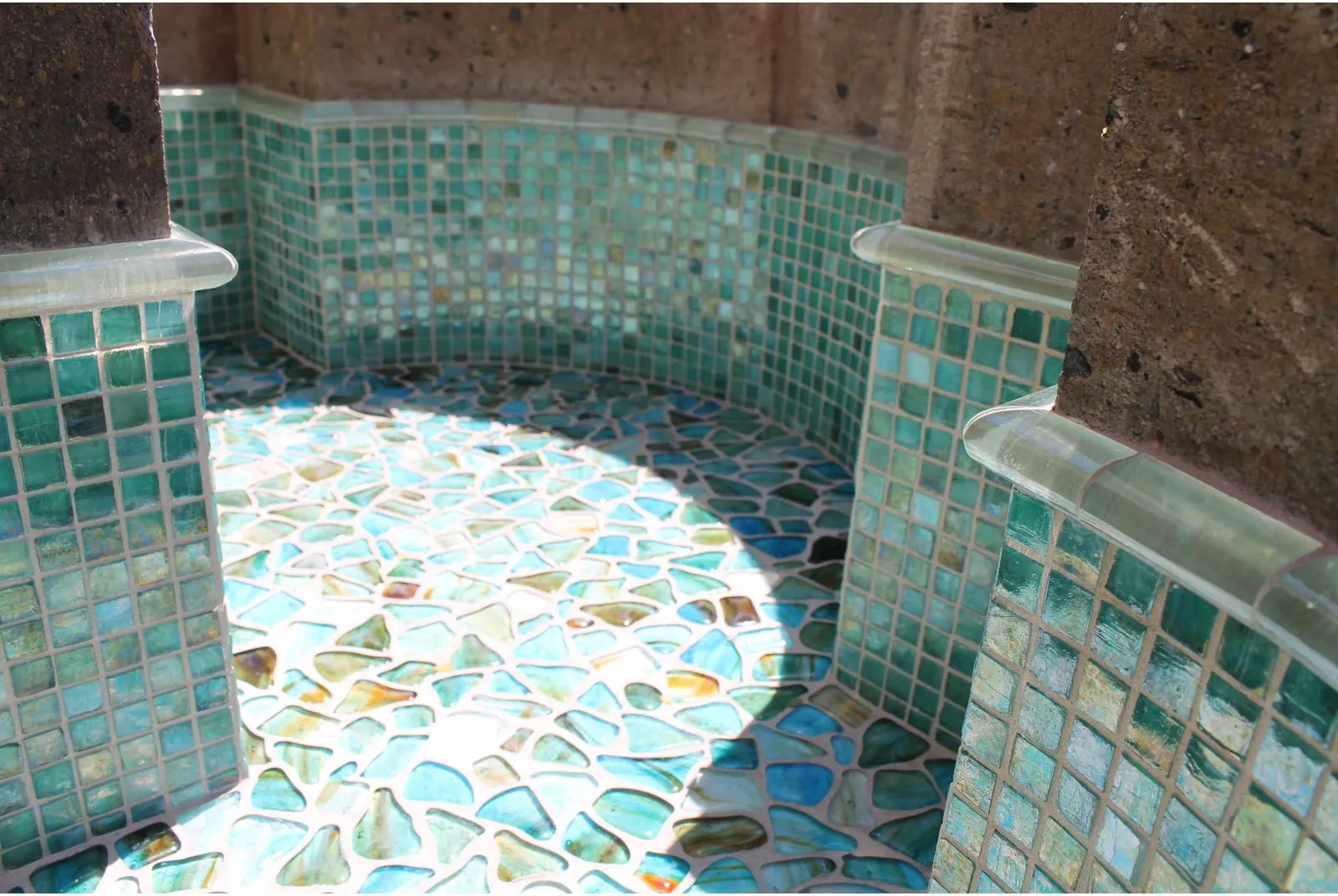 Modern desert patio with stone paving and tiled outdoor features.